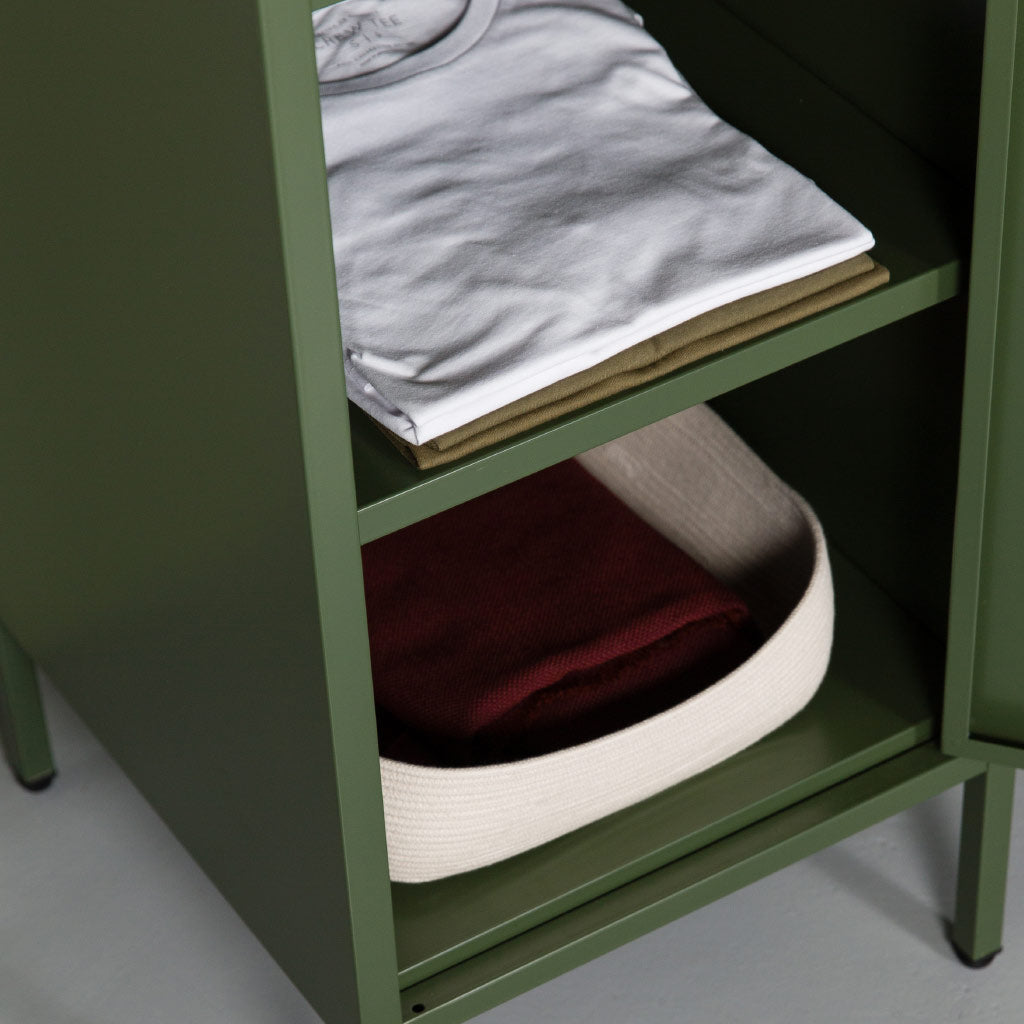 clothing packed neatly into dark olive steel locker